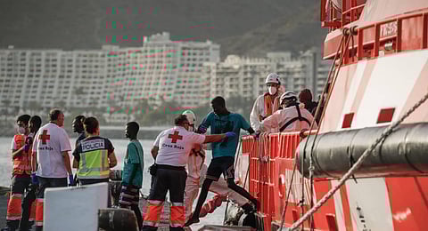 Migrants disembark from a Spanish Maritime Rescue vessel in the Port of Arguineguin on the Canary Island of Gran Canaria. (Photo | AFP)