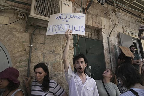 Activists gather outside of Nora Ghaith-Sub Laban's home after their eviction in Jerusalem's Old City, July 11, 2023. (Photo | AP)