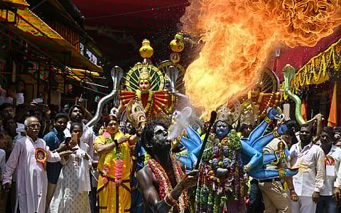 A performer breathes fire during the Rangam procession to the Ujjaini Mahankali Temple in Secunderabad on Monday. (Photo | Vinay Madapu)