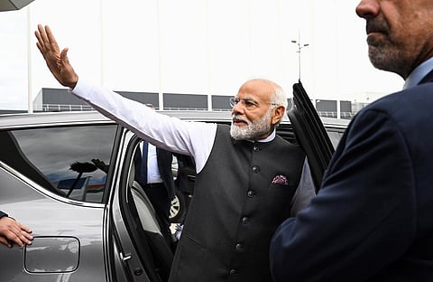 India's Prime Minister Narendra Modi waves as he arrives at the Orly airport in Orly, Paris' suburb, Thursday, July 13, 2023.