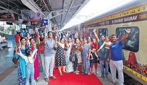Pilgrims pose for a group photograph before boarding the Bharat Gaurav Express at Secunderabad Railway Station on Wednesday. (Photo | Express)