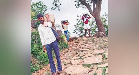  With no transport, residents have to carry groceries to their villages 