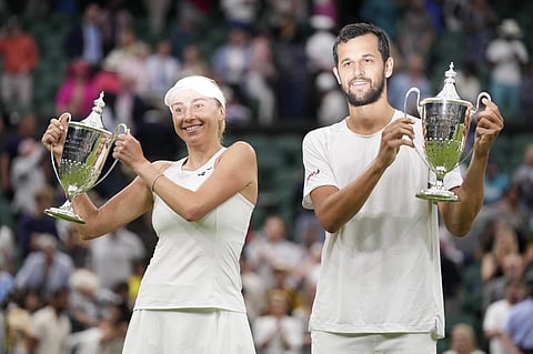 Croatia's Mate Savic, right, and Ukraine's Lyudmyla Kichenok celebrate with their trophies after winning the Wimbledon mixed doubles finals, July 13, 2023. (Photo | AP)