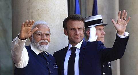 Prime Minister Narendra Modi and French President Emmanuel Macron wave before their talks at the Elysee Palace in Paris, Friday, July 14, 2023. (Photo | AP)