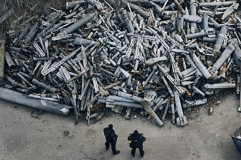 FILE - Police officers look at collected fragments of the Russian rockets, including cluster rounds, that hit Kharkiv, in Kharkiv, Ukraine, Saturday, Dec. 3, 2022. (Photo | AP)
