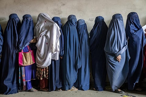 Afghan women wait to receive food rations distributed by a humanitarian aid group, in Kabul, Afghanistan, Tuesday, May 23, 2023. (Photo | AP)