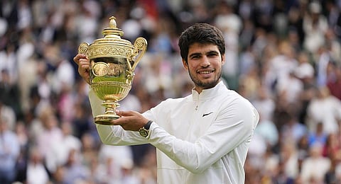 Spain's Carlos Alcaraz celebrates with the trophy after beating Serbia's Novak Djokovic to win the final of the men's singles Wimbledon tennis championships in London, July 16, 2023 (Photo | AP)