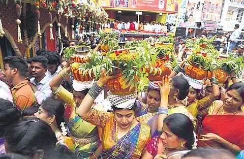 Devotees offer to bonams at Sri Simhavahini Mahankali temple in Old City on Saturday| sri loganathan velmurugan