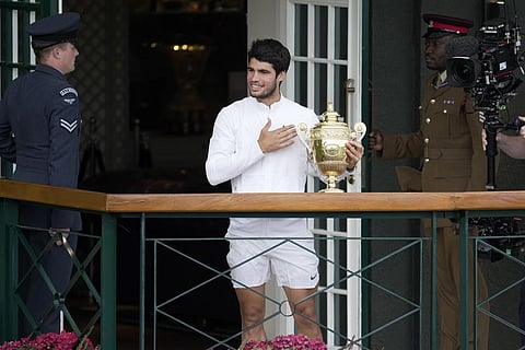 Carlos Alcaraz waves to fans from the balcony after beating Novak Djokovic in the men's singles final of the Wimbledon tennis championships in London, Sunday, July 16, 2023.(Photo | AP)