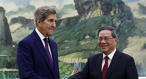 US Special Presidential Envoy for Climate John Kerry, left, and Chinese Premier Li Qiang shake hands before a meeting at the Great Hall of the People in Beijing Tuesday, July 18, 2023. (Photo | AP)