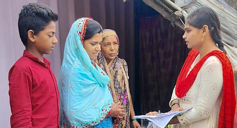 A volunteer interacts with beneficiaries during Suraksha Chakra. (Photo | Express)