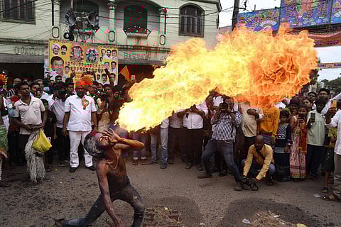 Performers throw flames during the Akkana Madanna temple Bonalu procession in Old City on Monday. (Photo | Vinay Madapu)