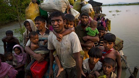 In this file image, Rohingya Muslims are seen carrying their children and belongings after crossing the border from Myanmar into Bangladesh. Image used for representational purpose only. (File | AP)