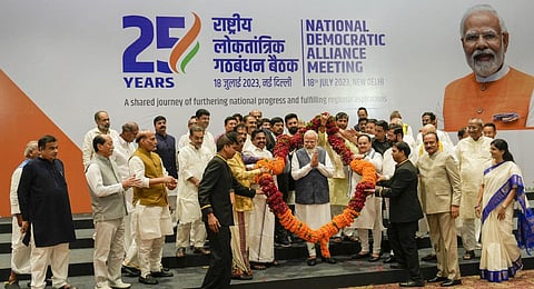 Prime Minister Narendra Modi is being garlanded by NDA leaders at the meeting of the National Democratic Alliance (NDA), in New Delhi, Tuesday, July 18, 2023. (Photo | PTI)