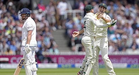 Australia's captain Pat Cummins celebrates with teammate Alex Carey after the dismissal of England's Jonny Bairstow. (Photo | AP)