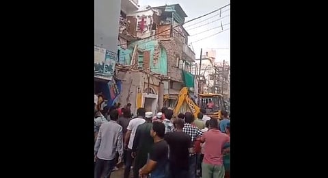 Illegal portions of properties belonging to 3 Muslim youth was demolished in Ujjain on July 19, a day after they were accused of 'spitting' water at a Hindu procession. (Videograb)