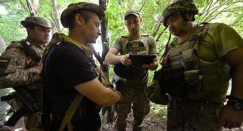 Ukrainian artillerymen work at a position on the front line near Bakhmut in the Donetsk region. (Photo | AFP)