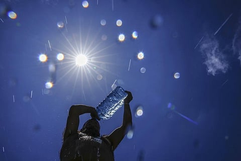 FILE - A man pours cold water onto his head to cool off on a sweltering hot day in the Mediterranean Sea in Beirut, Lebanon, Sunday, July 16, 2023. (Photo | AP)