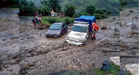 Vehicles stuck in debris after a cloudburst at Rohru area in Shimla district. (Photo | PTI)