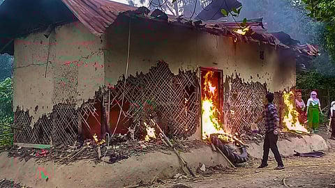 FILE: People set ablaze the house of Manipur sexual assault case accused, in Tuinomkhopi, Manipur, Friday, July 21, 2023. (Photo | PTI)