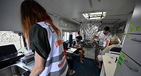 Volunteer medics carry out medical examinations for local residents in a mobile hospital in the village of Staryi Karavan, Donetsk region amid the invasion of Ukraine. (Photo | AFP)