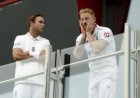 England's Stuart Broad, left and Ben Stokes look out from the players balcony after play was abandoned on the fourth day of the fourth Ashes Test match between England and Australia (Photo | AP)