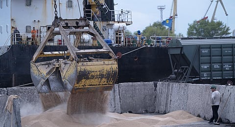 Workers load grain at a grain port in Izmail, Ukraine. (Photo | AP)