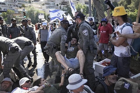 Israeli police disperse demonstrators blocking the road leading to the Knesset, Israel's parliament , during a protest against plans to overhaul the judicial system, in Jerusalem. (Photo | AP)