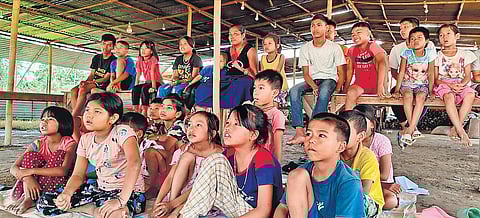 Children displaced by violence watch TV at a relief camp in Imphal on Sunday | pti
