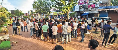 Traders gather after a heated exchange between permanent shop owners and street vendors at Market Building in Bhubaneswar on Sunday | Express