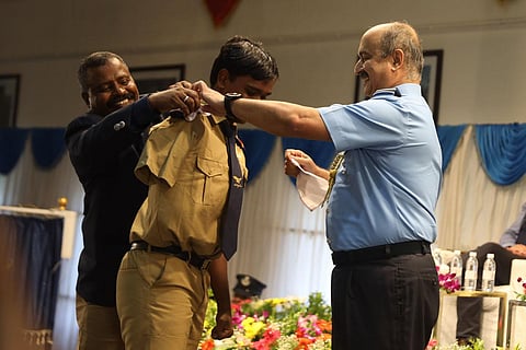 Air Chief Marshal VR Chaudhari pins a badge on a student at Hyderabad Public School’s investiture ceremony on Friday. (Photo | Sri Loganathan Velmurugan)