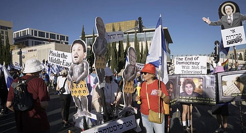 Israelis protest against Prime Minister Benjamin Netanyahu's judicial overhaul reform outside the parliament in Jerusalem, Sunday, July 23, 2023. (Photo | AP)