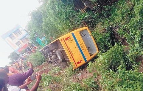 Locals gather to click pictures of the bus that overturned on the bypass road in Kesamudaram on Monday