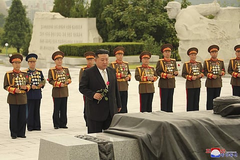 North Korean leader Kim Jong Un, foreground, prepares to offer a flower at a liberation war martyrs cemetery in Pyongyang, North Korea Tuesday, July 25, 2023. (Photo | AP)