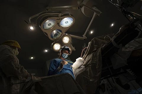 Neurosurgeon Nikita Lombrozo operates on a patient who sustained a shrapnel injury on the left part of the brain, at Mechnikov Hospital in Dnipro, Ukraine. (Photo | AP)