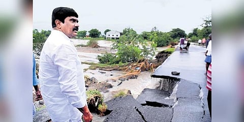 Roads and Buildings Minister Prashanth Reddy looks at a damaged road in Velpur mandal of Nizamabad district on Tuesday