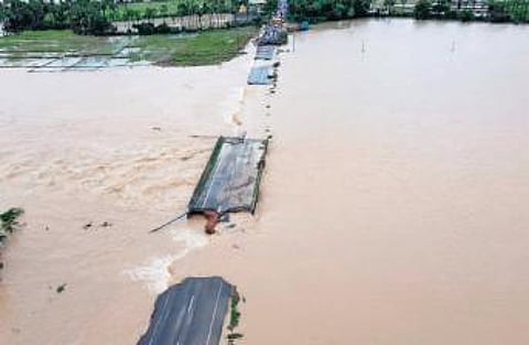 Only parts of a bridge remain in Nainpaka village on Thursday due to the floods following the relentless rains over the past week