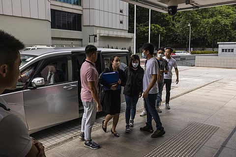The Department of Justice representatives enter High Court ahead of the hearing for an injunction to ban the 2019 protest song 'Glory to Hong Kong'. (Photo | AP)