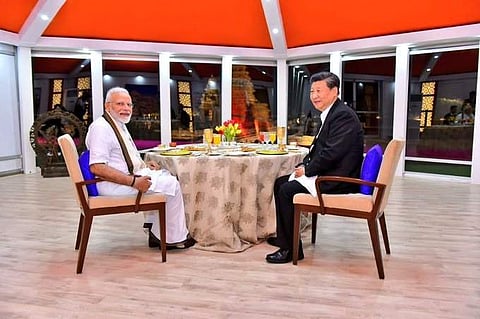 PM Modi and Chinese President Xi Jinping converse over dinner at Mahabalipuram during the informal summit. (File Photo | Twitter)