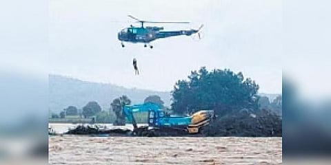 An IAF chopper evacuates locals taking refuge on a JCB in Ninepaka village