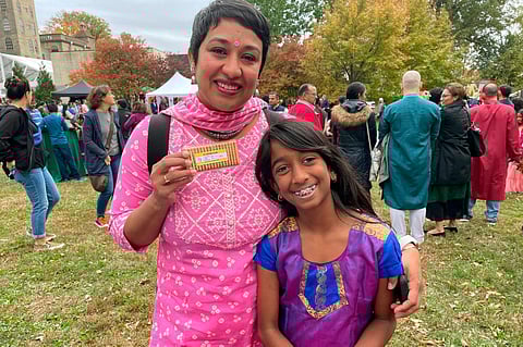 Advocacy group Indian American Impact, which runs the fact-checking site Desifacts.org, passes out Parle-G cookies with voting plan stickers for Diwali last year. (Photo | AP)