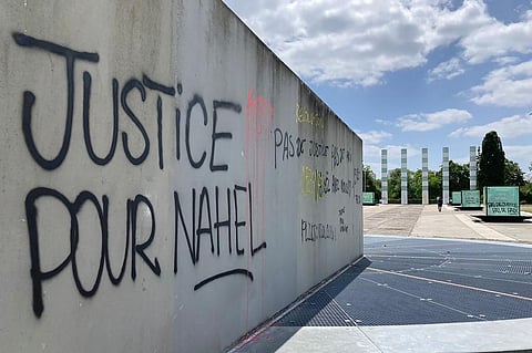 A graffiti reads 'Justice for Nahel' on a wall in Paris suburb Nanterre. (Photo | AP)