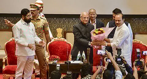 Maharashtra Governor Ramesh Bais congratulates the newly sworn-in Deputy CM Ajit Pawar at Raj Bhavan, in Mumbai, as CM Eknath Shinde looks on, July 2, 2023. (Photo | PTI)