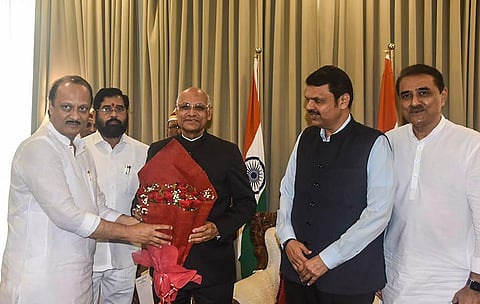 Maharashtra Governor Ramesh Bais with the newly-sworn in Dy CM Ajit Pawar. CM Eknath Shinde, DY CM CM Devendra Fadnavis and NCP leader Praful Patel are also seen. (PTI Photo)