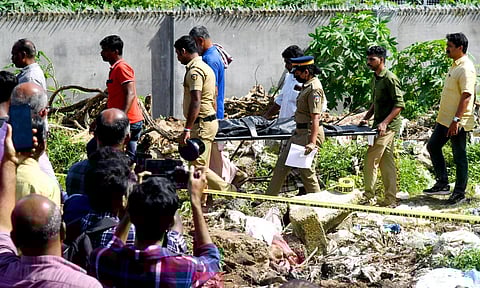 Police examining the body of a five-year-old who was raped and murdered before dumped at a place behind Aluva market. (Photo | TP Sooraj)