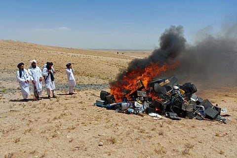 Members of Taliban set fire to a pile of musical instruments and equipment on the outskirts of Herat. (Photo | AFP)