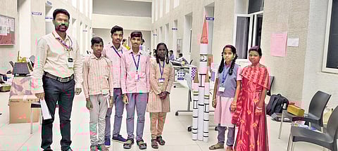 A Samuthirapandian with the students of GTR high school in Karikaiyur in Aracode village in Kothagiri taluk of the Nilgiris district | Express