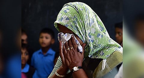 The headmistress of the school at Thaikkattukara, near Aluva, breaks down when the mortal remains of the five-year-old girl were brought there for the public to pay homage on Sunday | Express