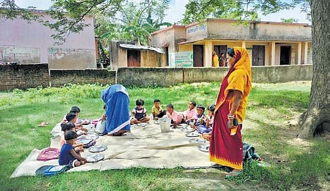 Kids of the anganwadi centre being served MDM under a tree I EXPRESS