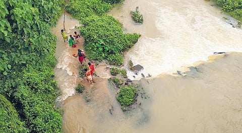 File pic of a family caught in a flood at Chemmaruthy in Thiruvananthapuram